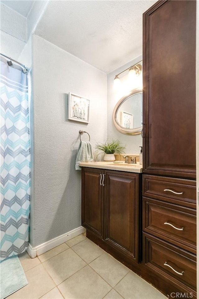 11947 Vivienda Ct, Grand Terrace, CA 92313 - full bathroom with tile patterned floors, vanity, baseboards, and a shower with curtain