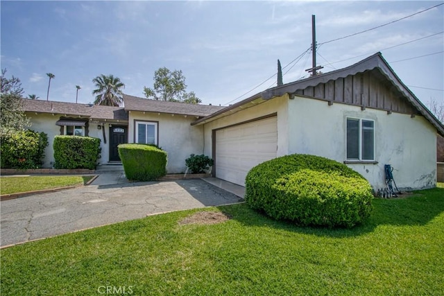11947 Vivienda Ct, Grand Terrace, CA 92313 - ranch-style house with a front lawn, aphalt driveway, a garage, and stucco siding