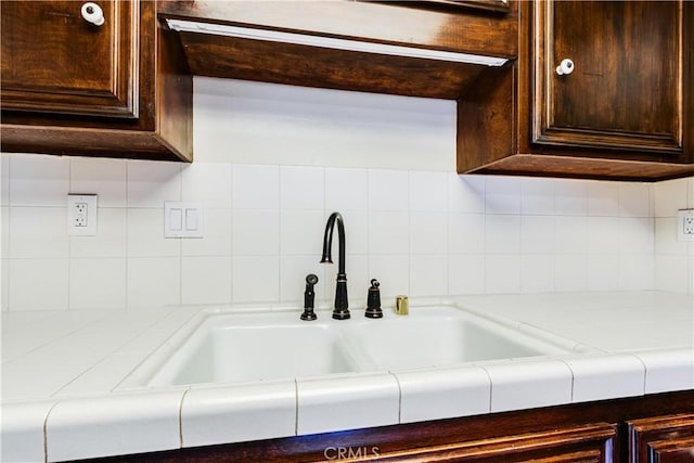 506 W Sierra Madre Blvd Unit D, Sierra Madre, CA 91024 - room details featuring light countertops, backsplash, dark brown cabinetry, and a sink