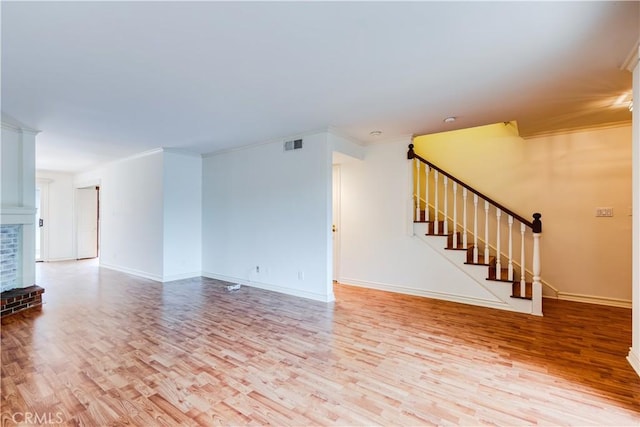 506 W Sierra Madre Blvd Unit D, Sierra Madre, CA 91024 - unfurnished living room featuring stairs, baseboards, wood finished floors, visible vents, and ornamental molding