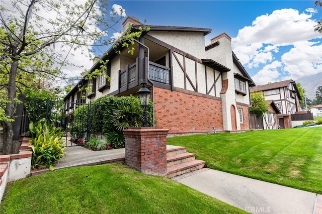 506 W Sierra Madre Blvd Unit D, Sierra Madre, CA 91024 - exterior space featuring a front lawn, fence, a balcony, stucco siding, and brick siding