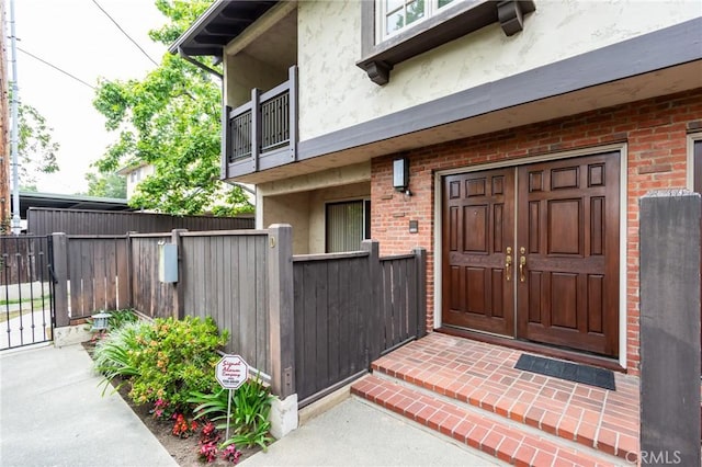 506 W Sierra Madre Blvd Unit D, Sierra Madre, CA 91024 - entrance to property with a gate, brick siding, fence, a balcony, and stucco siding