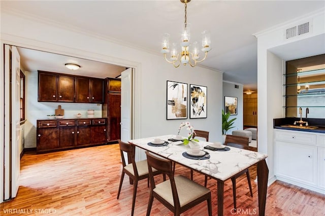 506 W Sierra Madre Blvd Unit D, Sierra Madre, CA 91024 - dining room with crown molding, a chandelier, indoor wet bar, light wood-type flooring, and visible vents