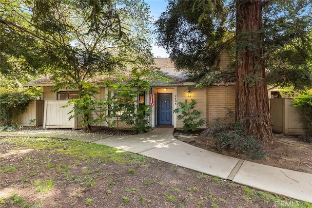 2403 Holly Ave, Chico, CA 95926 - view of property hidden behind natural elements featuring fence and brick siding
