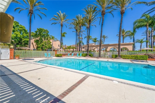 pool featuring fence and a patio