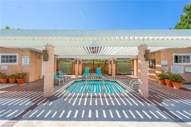 view of pool featuring fence