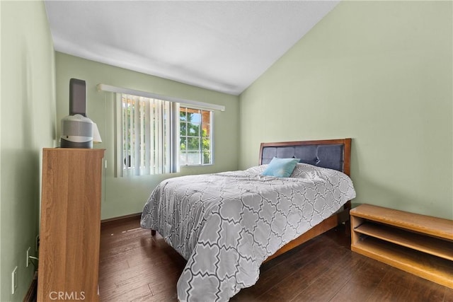 bedroom featuring wood-type flooring and vaulted ceiling