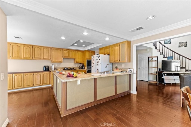 kitchen featuring ornamental molding, a peninsula, visible vents, and dark wood-type flooring