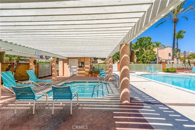 pool with a hot tub, a pergola, fence, and a patio