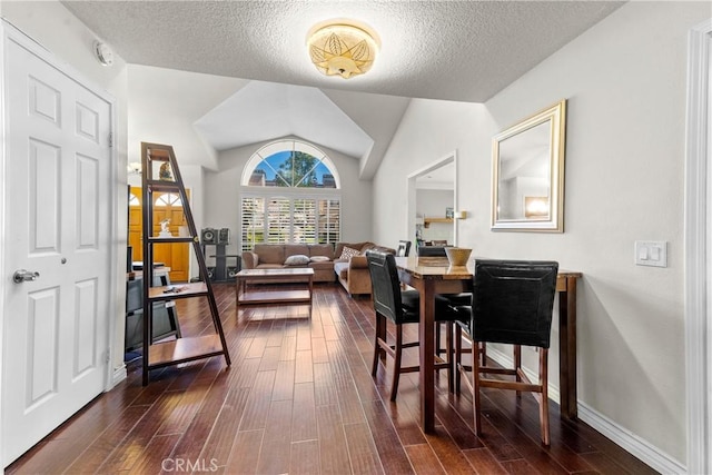dining space with vaulted ceiling, dark wood-style flooring, a textured ceiling, and baseboards