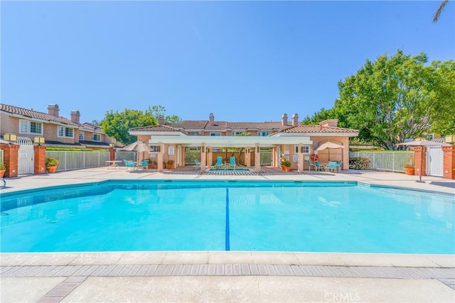 pool featuring fence and a patio
