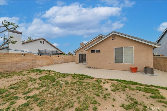 14850 Filly Ln, Fontana, CA 92336 - back of property with a patio, a fenced backyard, a chimney, and stucco siding