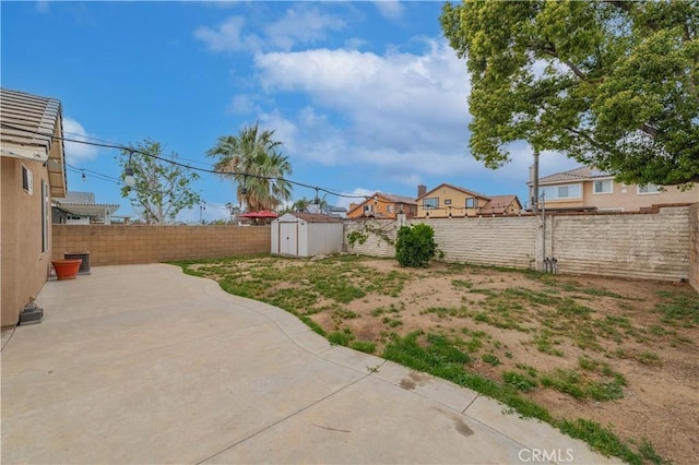 14850 Filly Ln, Fontana, CA 92336 - view of yard featuring an outbuilding, a patio area, a fenced backyard, and a shed