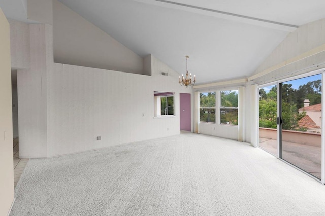 unfurnished room with an inviting chandelier, a healthy amount of sunlight, beam ceiling, high vaulted ceiling, and carpet flooring