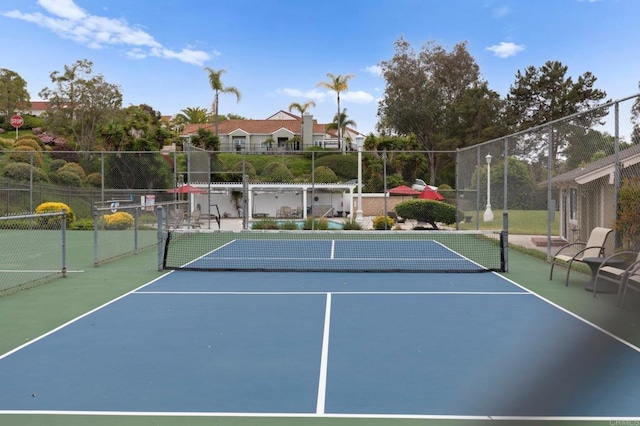view of sport court featuring fence