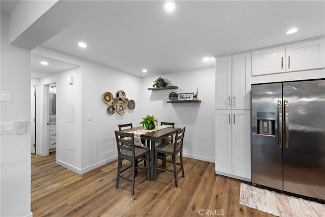 dining area with baseboards, recessed lighting, and wood finished floors