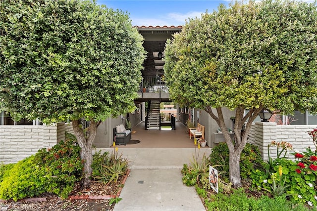 surrounding community featuring stairs and a patio area