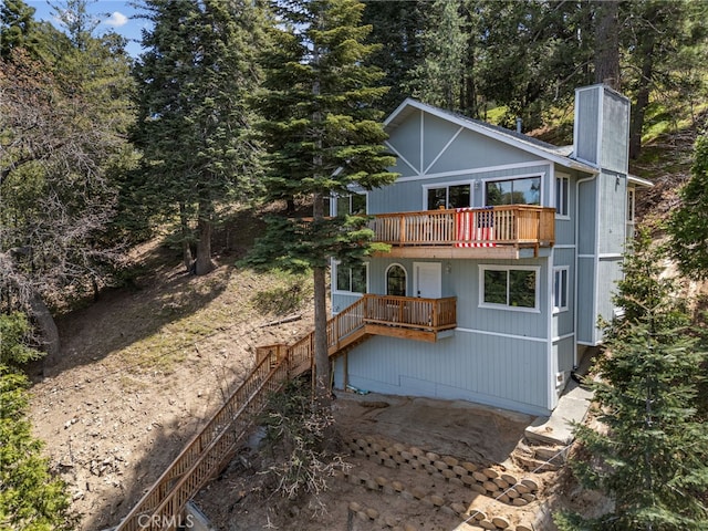 781 Arbula Dr, Crestline, CA 92325 - back of property with a chimney and a balcony