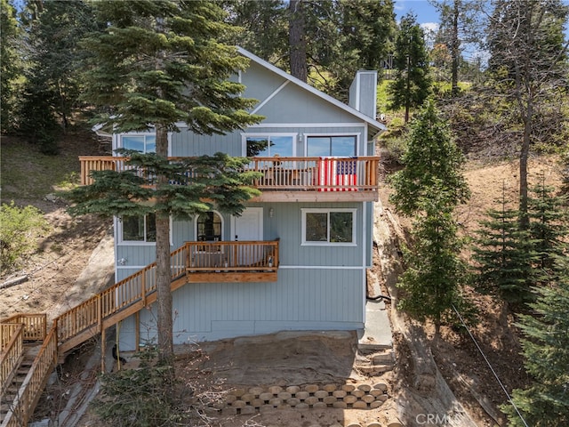 781 Arbula Dr, Crestline, CA 92325 - rear view of house with stairs and a chimney