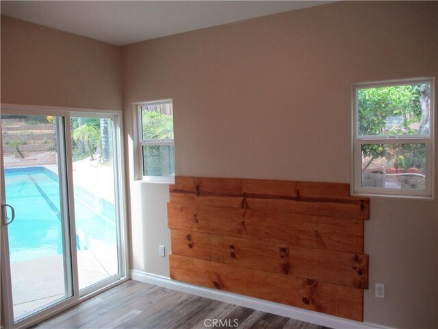 22956 Akwo Cir, Wildomar, CA 92595 - spare room with wood finished floors, healthy amount of natural light, and baseboards