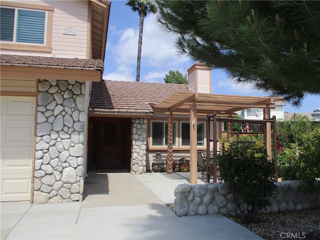 22956 Akwo Cir, Wildomar, CA 92595 - property entrance featuring stone siding and a chimney