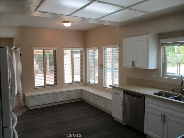 22956 Akwo Cir, Wildomar, CA 92595 - kitchen with stainless steel dishwasher, freestanding refrigerator, a sink, white cabinetry, and light countertops