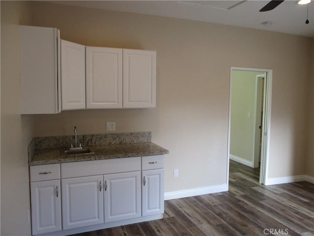 22956 Akwo Cir, Wildomar, CA 92595 - kitchen with a sink, white cabinets, dark wood-style floors, baseboards, and ceiling fan