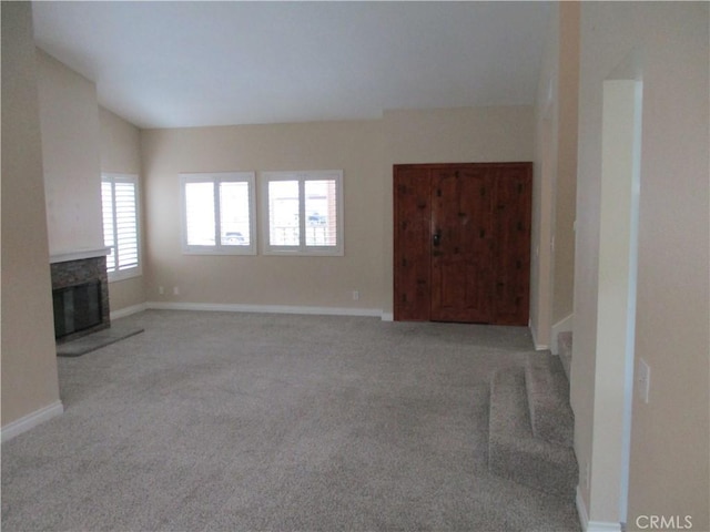 22956 Akwo Cir, Wildomar, CA 92595 - unfurnished living room featuring carpet floors, a fireplace with raised hearth, and baseboards