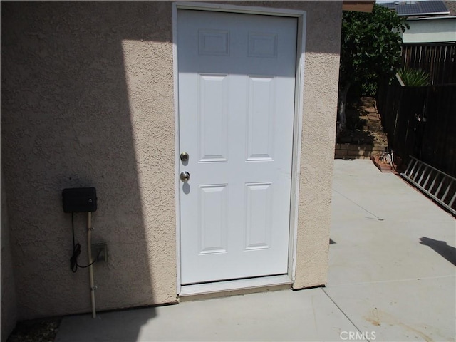22956 Akwo Cir, Wildomar, CA 92595 - property entrance with stucco siding and fence