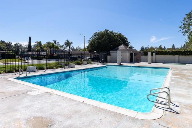 pool featuring a patio and fence