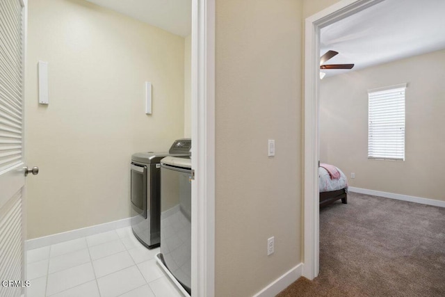 washroom featuring baseboards, ceiling fan, laundry area, and washing machine and dryer