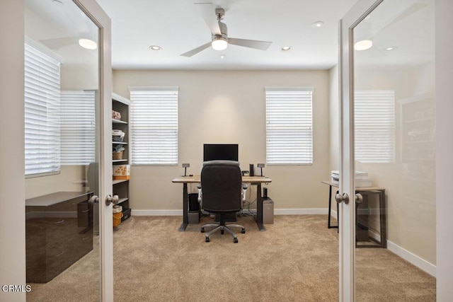 home office with plenty of natural light, carpet, and french doors