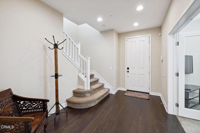 entryway featuring recessed lighting, baseboards, wood finished floors, and stairway