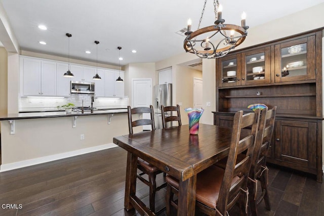 dining area with an inviting chandelier, visible vents, recessed lighting, and dark wood-type flooring