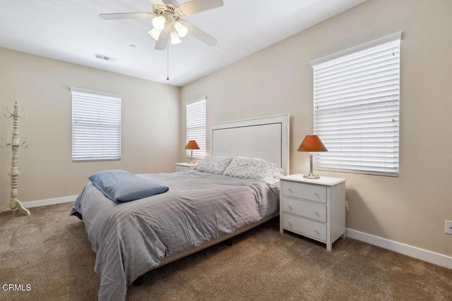 bedroom with carpet floors, baseboards, and visible vents