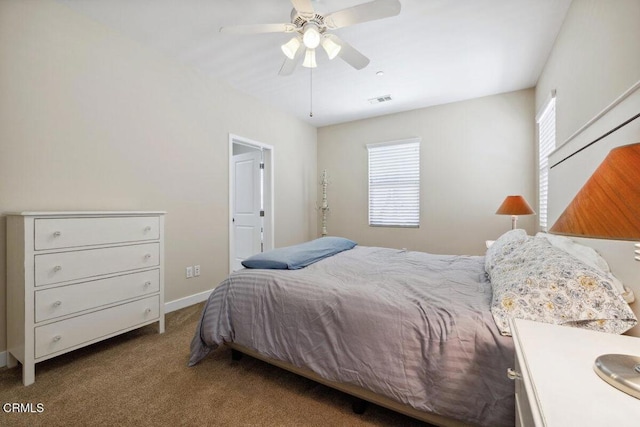 carpeted bedroom with visible vents, a ceiling fan, and baseboards