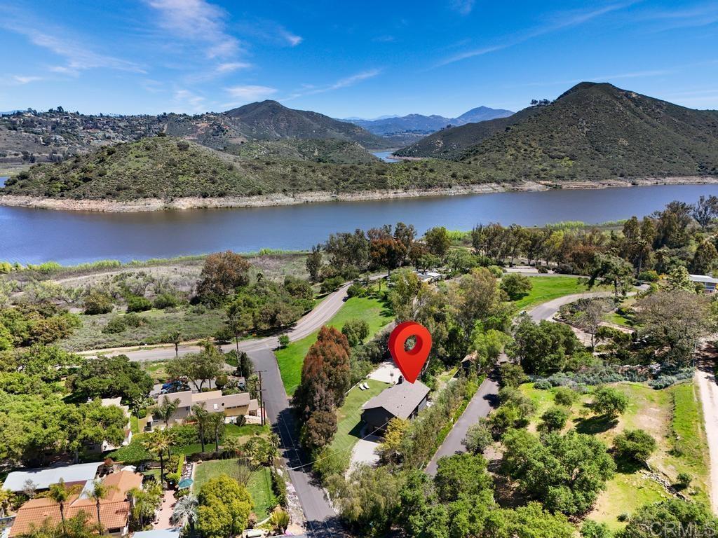 birds eye view of property featuring a water and mountain view