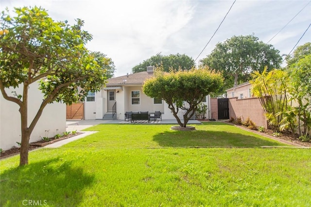 3540 S Sycamore Ave, Los Angeles, CA 90016 - rear view of house with a yard, a patio area, stucco siding, and fence