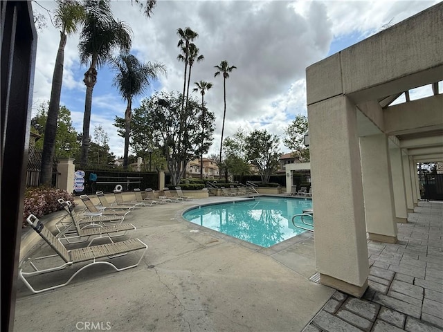 community pool with a patio area