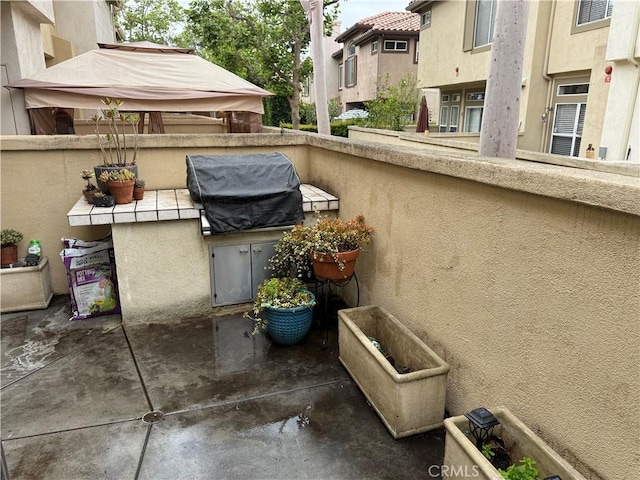 view of patio featuring area for grilling and a grill