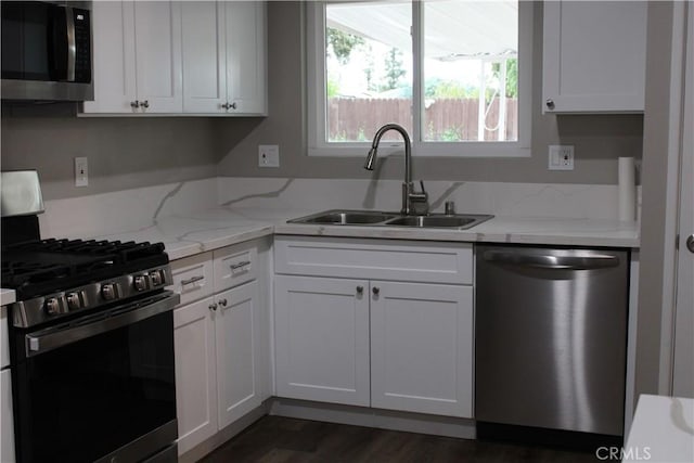 26231 Pine Valley Rd, Menifee, CA 92586 - kitchen with appliances with stainless steel finishes, a sink, white cabinetry, and dark wood-type flooring