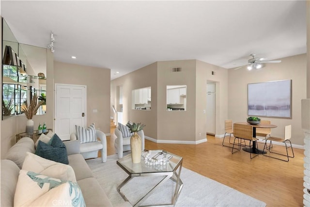 living room with baseboards, recessed lighting, a ceiling fan, visible vents, and light wood finished floors