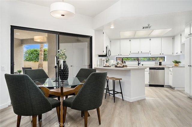 255 S Avenida Caballeros Unit 106, Palm Springs, CA 92262 - dining area featuring visible vents and light wood-type flooring