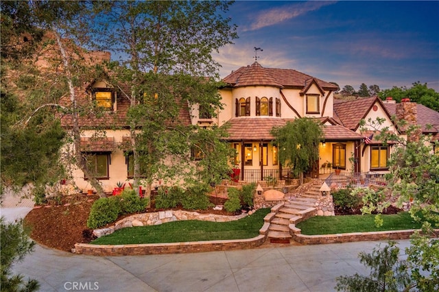 32140 Windrush Rd, Agua Dulce, CA 91390 - tudor house with stairway, covered porch, and stucco siding