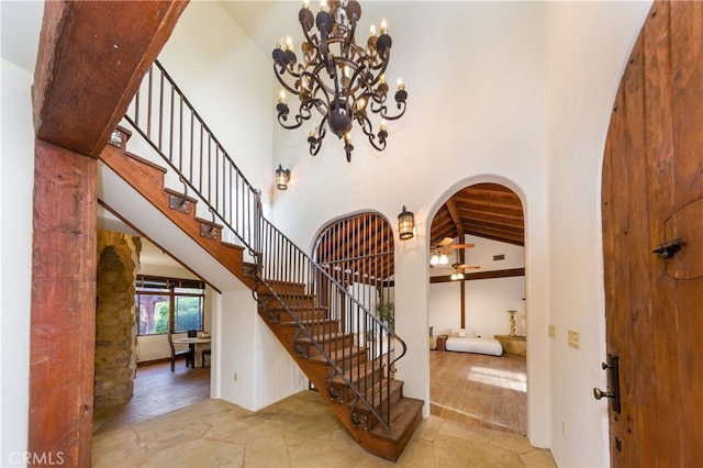 32140 Windrush Rd, Agua Dulce, CA 91390 - entrance foyer with arched walkways, an inviting chandelier, stone finish flooring, and stairway