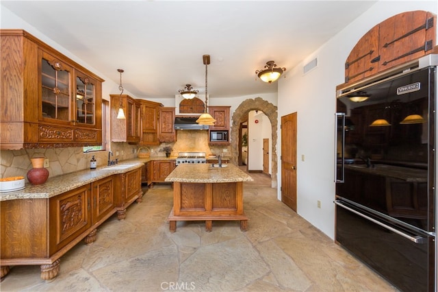32140 Windrush Rd, Agua Dulce, CA 91390 - kitchen featuring visible vents, black fridge, a sink, backsplash, and range