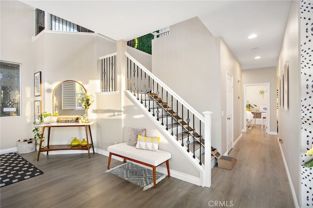33081 Yucca St, Temecula, CA 92592 - stairs featuring baseboards, wood finished floors, recessed lighting, and a towering ceiling