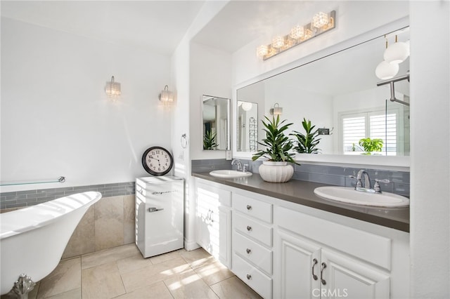 33081 Yucca St, Temecula, CA 92592 - bathroom featuring a freestanding tub, tile patterned flooring, double vanity, tile walls, and wainscoting