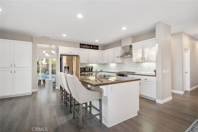33081 Yucca St, Temecula, CA 92592 - kitchen featuring wall chimney exhaust hood, dark wood-type flooring, a sink, white cabinets, and recessed lighting
