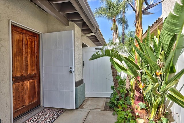 doorway to property with stucco siding